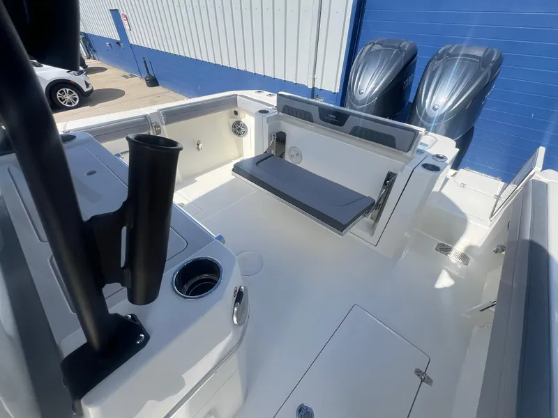 Slide: The Image of 2025 Cobia 285 Open Center Console boat interior with seating and dual engines. - 6