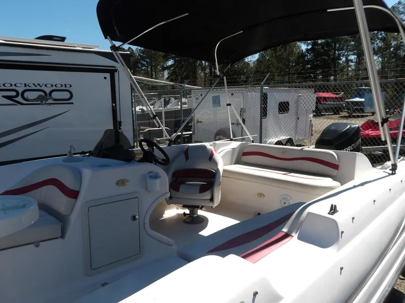 Slide: The Image of 2008 Starcraft Stardeck 200 boat with seating, canopy, and control console in a storage area. - 10