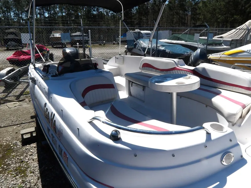 Slide: The Image of 2008 Starcraft Stardeck 200 boat with seating and table, parked outdoors. - 14