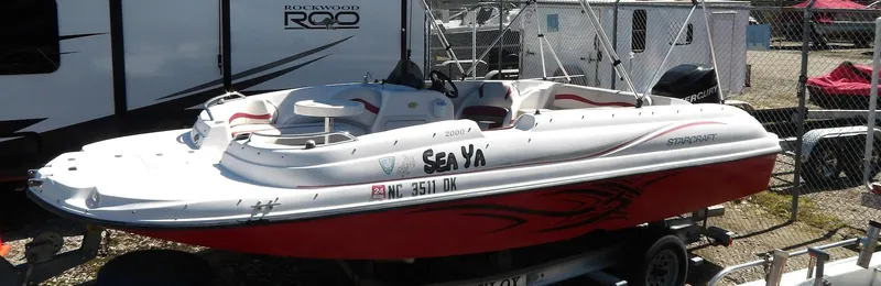 Slide: The Image of 2008 Starcraft Stardeck 200 boat with red and white design on a trailer. - 4