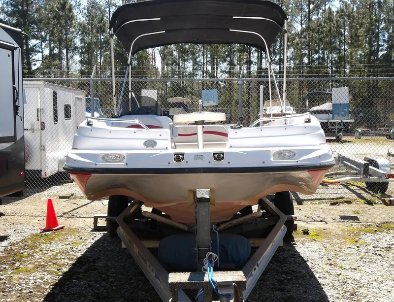 Slide: The Image of 2008 Starcraft Stardeck 200 boat on trailer, parked outdoors with canopy. - 6