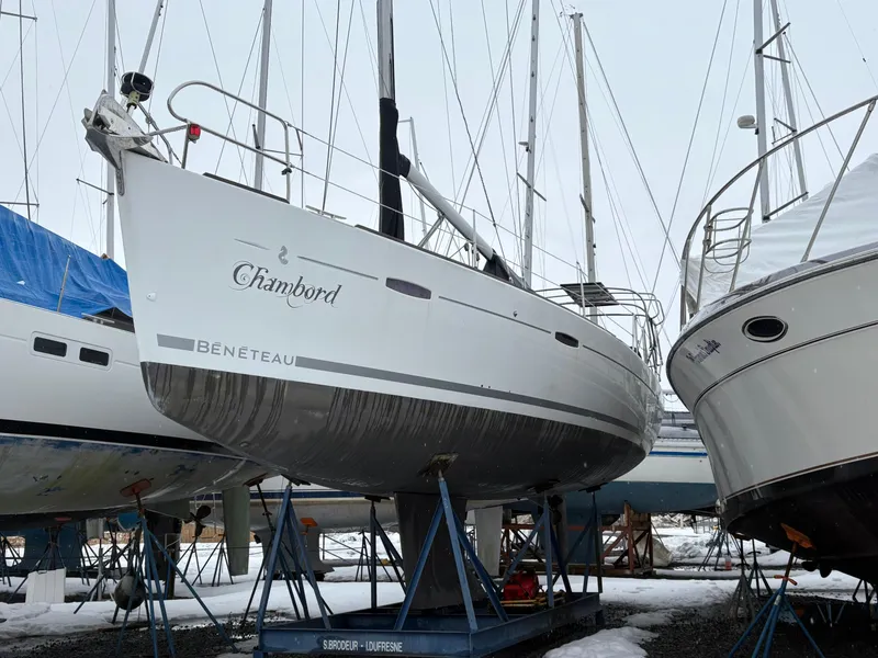 Slide: The Image of 2011 Beneteau Oceanis 40 sailboat on stands in a snowy boatyard. - 0