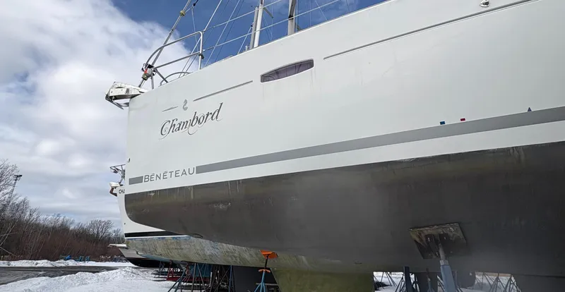 Slide: The Image of Beneteau Oceanis 40 sailboat, 2011 model, on land for maintenance under cloudy sky. - 1