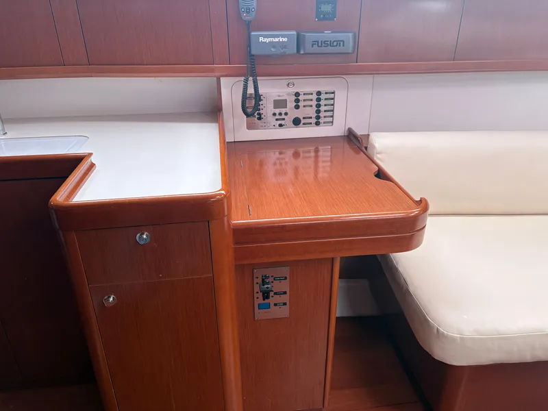 Slide: The Image of Interior of 2011 Beneteau Oceanis 40 yacht with navigation equipment and seating area. - 11