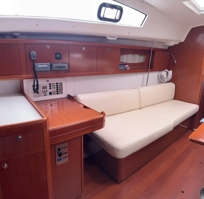 Slide: The Image of Interior of 2011 Beneteau Oceanis 40 yacht with wooden cabinetry and white seating. - 12