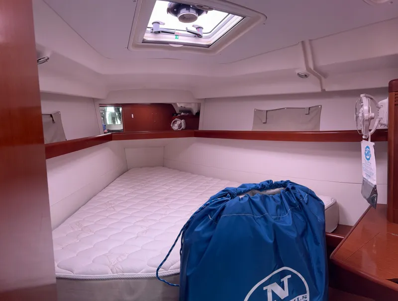 Slide: The Image of Cabin interior of 2011 Beneteau Oceanis 40 sailboat with bed and blue bag. - 13
