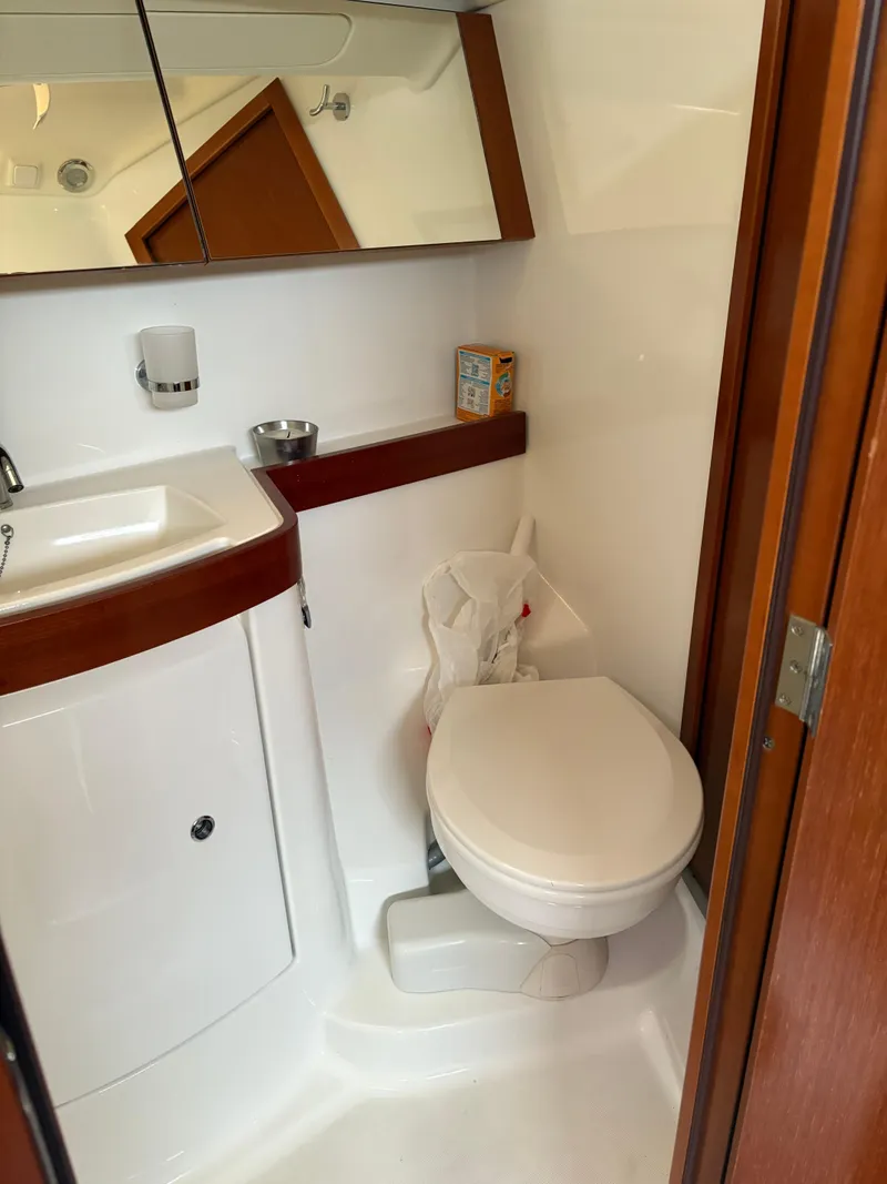 Slide: The Image of 2011 Beneteau Oceanis 40 yacht bathroom with sink, toilet, and mirror. - 19
