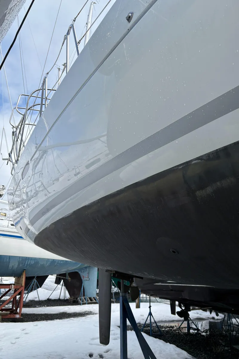 Slide: The Image of 2011 Beneteau Oceanis 40 sailboat hull in dry dock, side view. - 5