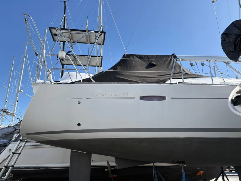 Slide: The Image of 2011 Beneteau Oceanis 40 sailboat on dry dock, side view under clear blue sky. - 6