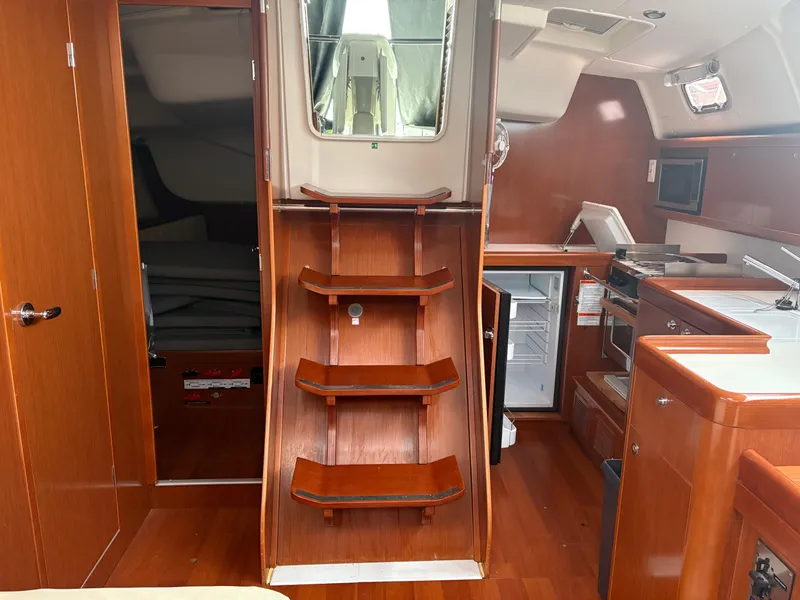 Slide: The Image of Interior of 2011 Beneteau Oceanis 40 sailboat with wooden stairs and modern kitchen. - 9