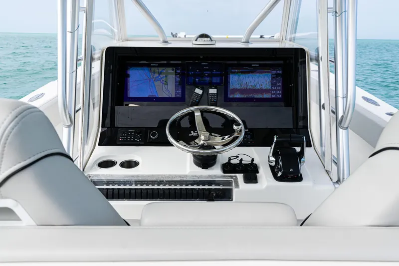 Slide: The Image of 2015 SeaVee 390Z boat dashboard with navigation screens and steering wheel. - 11