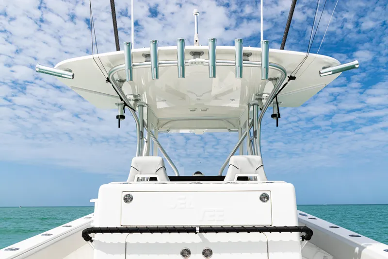 Slide: The Image of 2015 SeaVee 390Z boat with T-top against a blue sky and ocean backdrop. - 12