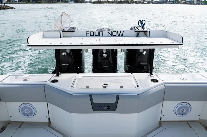 Slide: The Image of 2015 SeaVee 390Z boat with triple Mercury engines, fishing station, and ocean backdrop. - 15