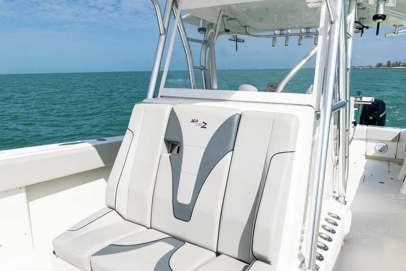 Slide: The Image of 2015 SeaVee 390Z boat interior with cushioned seating, ocean backdrop. - 20