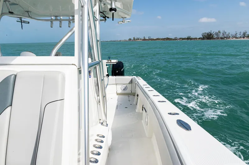 Slide: The Image of 2015 SeaVee 390Z boat cruising on turquoise waters near a distant shoreline. - 21