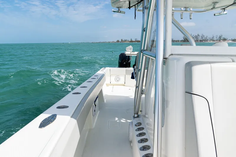 Slide: The Image of 2015 SeaVee 390Z boat cruising on turquoise waters under a clear blue sky. - 22