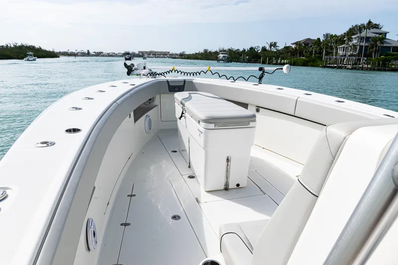 Slide: The Image of 2015 SeaVee 390Z boat interior with seating and storage, cruising on a calm waterway. - 27