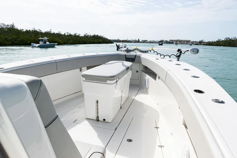 Slide: The Image of 2015 SeaVee 390Z boat interior with seating and storage, cruising on calm waters. - 28