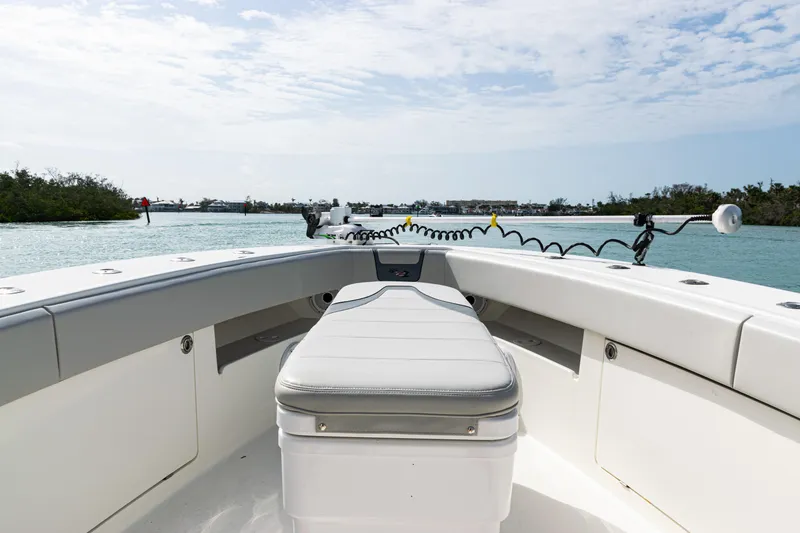 Slide: The Image of 2015 SeaVee 390Z boat interior with seating, navigating calm waters under a partly cloudy sky. - 29
