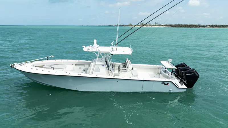 Slide: The Image of 2015 SeaVee 390Z boat on turquoise water, featuring triple outboard engines. - 3