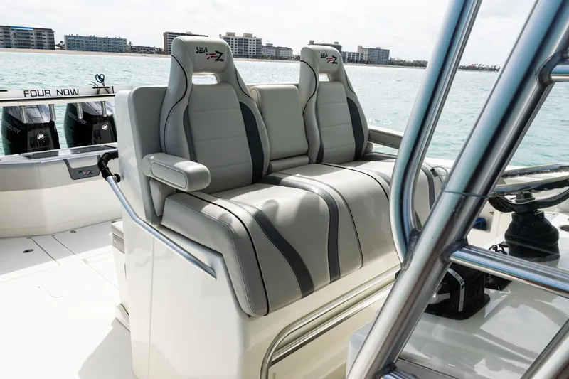 Slide: The Image of 2015 SeaVee 390Z boat interior with dual gray seats, ocean view in background. - 35