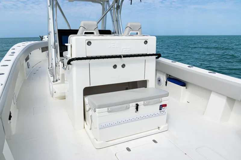 Slide: The Image of 2015 SeaVee 390Z boat interior with seating and storage, cruising on open water. - 36