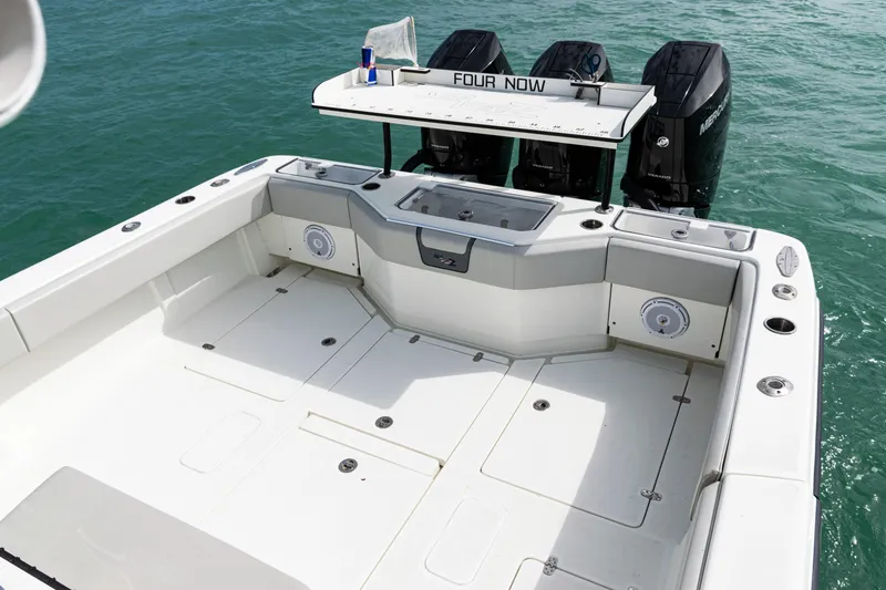 Slide: The Image of 2015 SeaVee 390Z boat deck with triple outboard engines on clear water. - 39