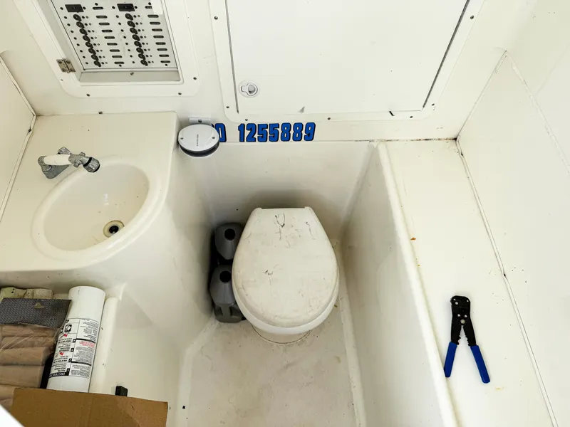 Slide: The Image of 2015 SeaVee 390Z boat bathroom with sink, toilet, and control panel. - 44