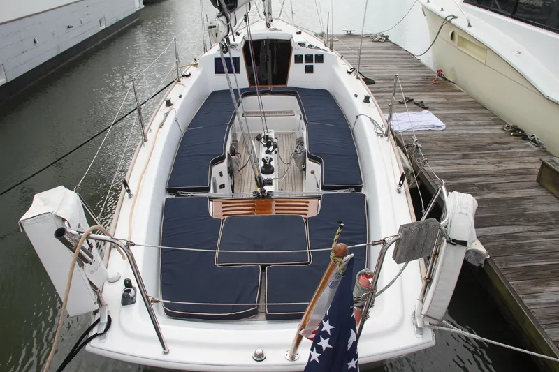 Slide: The Image of 2009 e Sailing Yachts e33 docked, featuring spacious deck and seating area. - 13