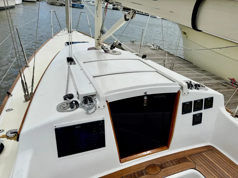Slide: The Image of 2009 e Sailing Yachts e33 sailboat deck with control panels and wooden accents. - 16