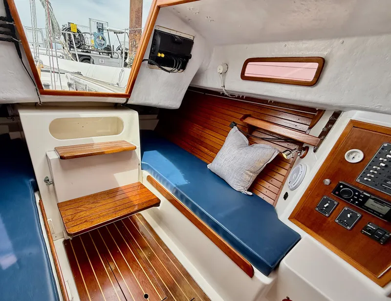 Slide: The Image of 2009 e Sailing Yachts e33 interior with wooden accents and blue seating. - 21