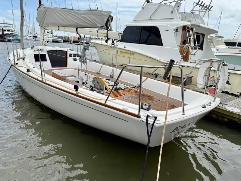 Slide: The Image of 2009 e Sailing Yachts e33 docked at marina, featuring sleek design and wooden deck. - 3
