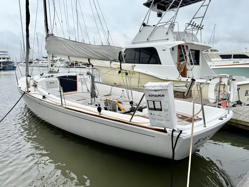 Slide: The Image of 2009 e Sailing Yachts e33 docked at marina, featuring sleek design and white hull. - 4