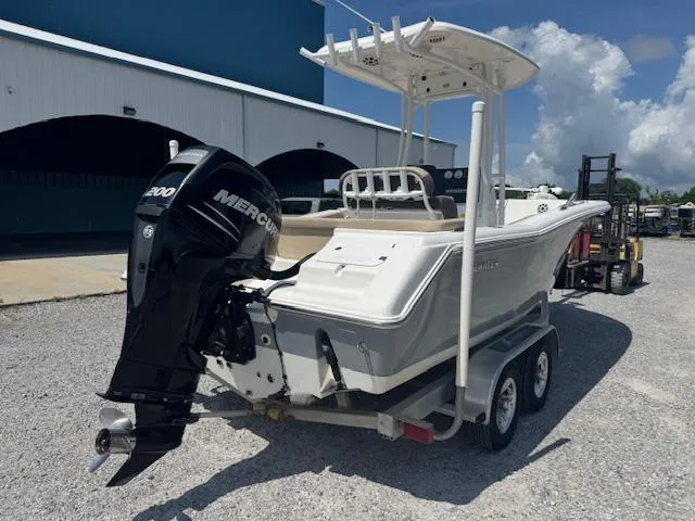 Slide: The Image of 2018 Tidewater 220 LXF boat on trailer with Mercury engine, parked outdoors. - 10