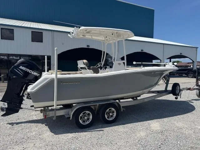 Slide: The Image of 2018 Tidewater 220 LXF boat on trailer with Mercury engine, parked outdoors. - 11