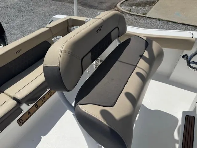 Slide: The Image of 2018 Tidewater 220 LXF boat interior with beige seating and cup holders. - 14