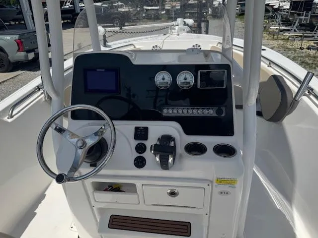 Slide: The Image of 2018 Tidewater 220 LXF boat console with steering wheel and gauges. - 15