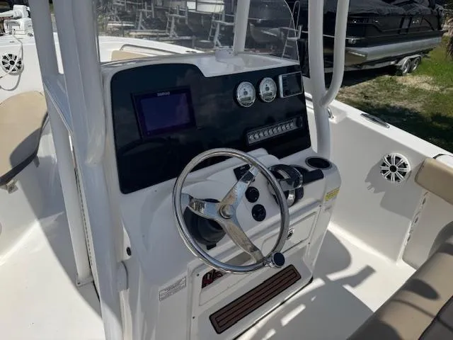 Slide: The Image of 2018 Tidewater 220 LXF boat dashboard with steering wheel and controls. - 16