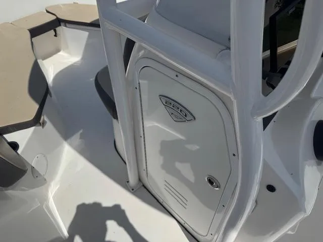 Slide: The Image of 2018 Tidewater 220 LXF boat interior with seating and storage compartment. - 17