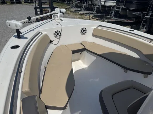 Slide: The Image of 2018 Tidewater 220 LXF boat interior with beige seating and speakers. - 18