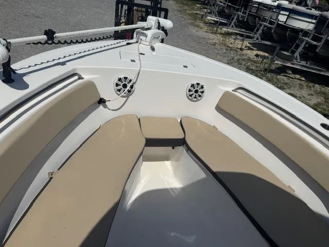 Slide: The Image of 2018 Tidewater 220 LXF boat interior with beige seating and speakers. - 19