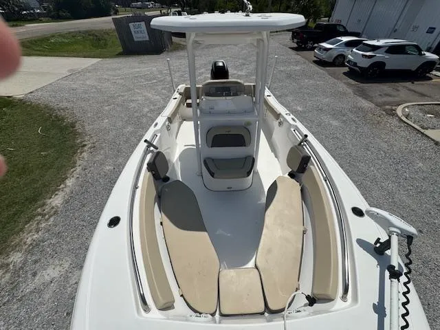 Slide: The Image of 2018 Tidewater 220 LXF boat with spacious deck and seating, parked on gravel. - 21