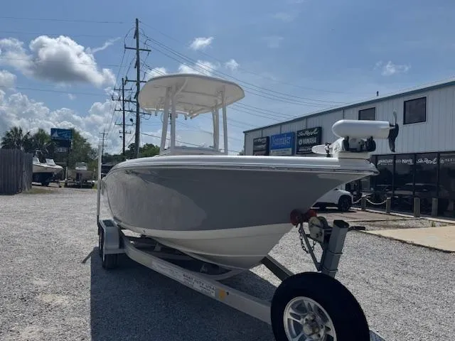 Slide: The Image of 2018 Tidewater 220 LXF boat on trailer, parked outdoors under a clear sky. - 3