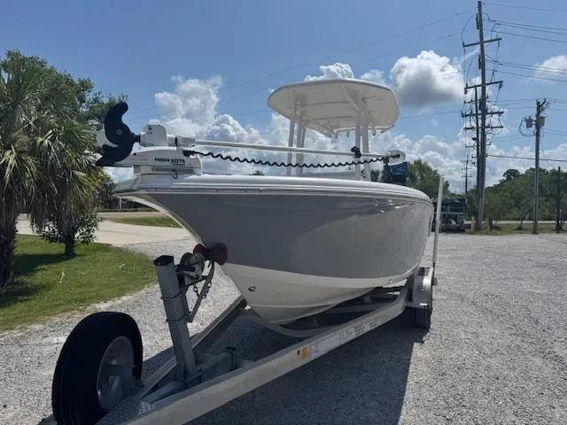 Slide: The Image of 2018 Tidewater 220 LXF boat on trailer under clear sky. - 4