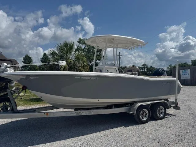 Slide: The Image of 2018 Tidewater 220 LXF boat on trailer under a cloudy sky. - 5