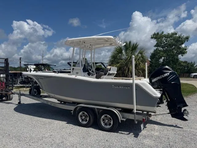 Slide: The Image of 2018 Tidewater 220 LXF boat on trailer with Mercury engine, parked outdoors. - 7