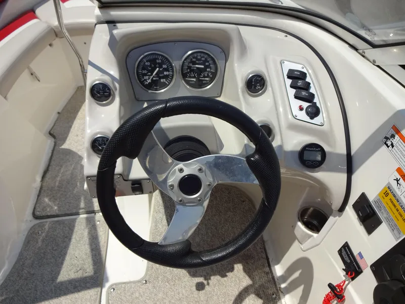 Slide: The Image of Steering console of a 2007 Larson 206 Senza boat with gauges and controls. - 10