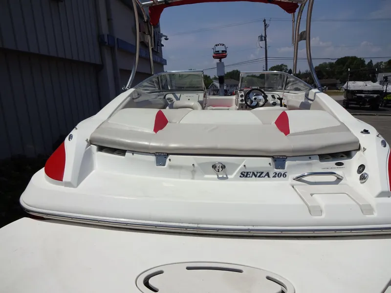 Slide: The Image of 2007 Larson 206 Senza boat, rear view, white and red accents, outdoor setting. - 5