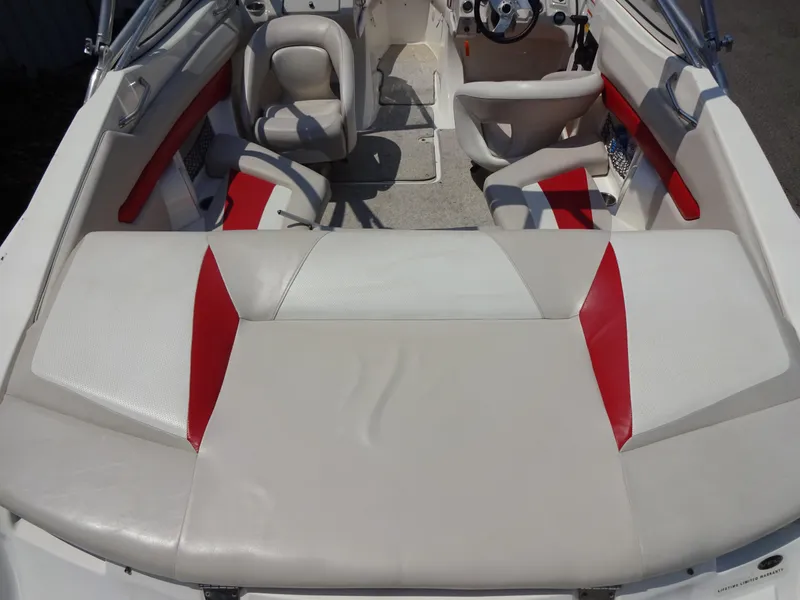 Slide: The Image of Interior of a 2007 Larson 206 Senza boat with red and white seating. - 6