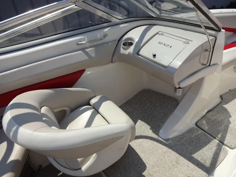 Slide: The Image of 2007 Larson 206 Senza boat interior with white seating and dashboard. - 9